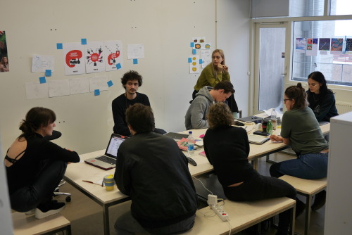 People sitting around a table working in a classroom