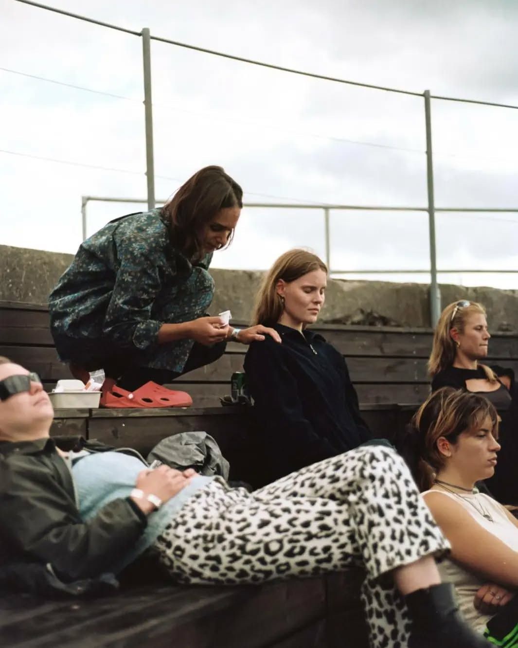 Me at music festival KUNE giving ear acupuncture. I am sitting close to someone that just received the treatment, and I am holding their shoulder